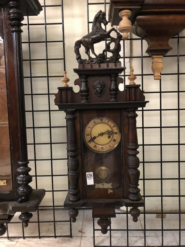 EARLY WALL CLOCK ( NOT SURE IF THE POTTERY HORSE IS: EARLY WALL CLOCK ( NOT SURE IF THE POTTERY HORSE IS ORIGINAL, OR ADDED ON LATER ), MEASURES 35" TO TOP OF HORSE, CLOCK RUNS, HAS KEY AND PENDULUM, DARK FINISH, A SMALL VENEER CHIP ON FRONT, FROM SHOP