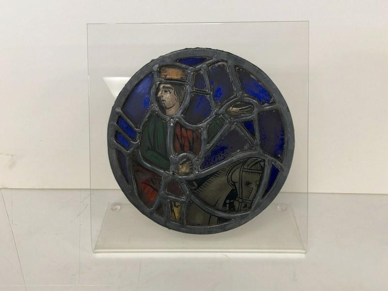 EARLY ROUND STAINED GLASS SECTION, MOUNTED ON: EARLY ROUND STAINED GLASS SECTION, MOUNTED ON PLEXIGLASS STAND, MEASURES 8" ACROSS. IN NICE CONDITION. FROM EVELYNE DAITZ ESTATE - EVELYNE DAITZ (1936-2019) WAS A SWISS BORN AMERICAN ART DEALER, CURAT