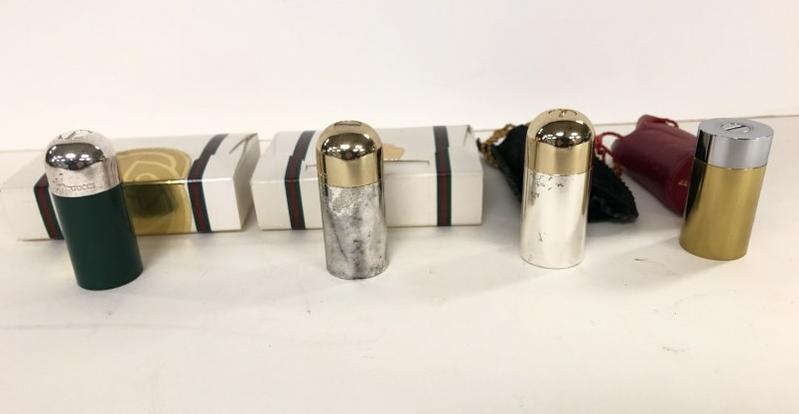 GUCCI (4) SALT & PEPPER SHAKERS, 2 WITH ORIGINAL GIFT: GUCCI (4) SALT & PEPPER SHAKERS, 2 WITH ORIGINAL GIFT BOXES, AND 2 IN BAGS (RED LEATHER BAG HAS TEAR AT TOP OF BAG), IN VERY NICE ESTATE CONDITION, THEY MEASURE 2.5" (3 OF THEM & DIFFERENT SHAPED ONE 