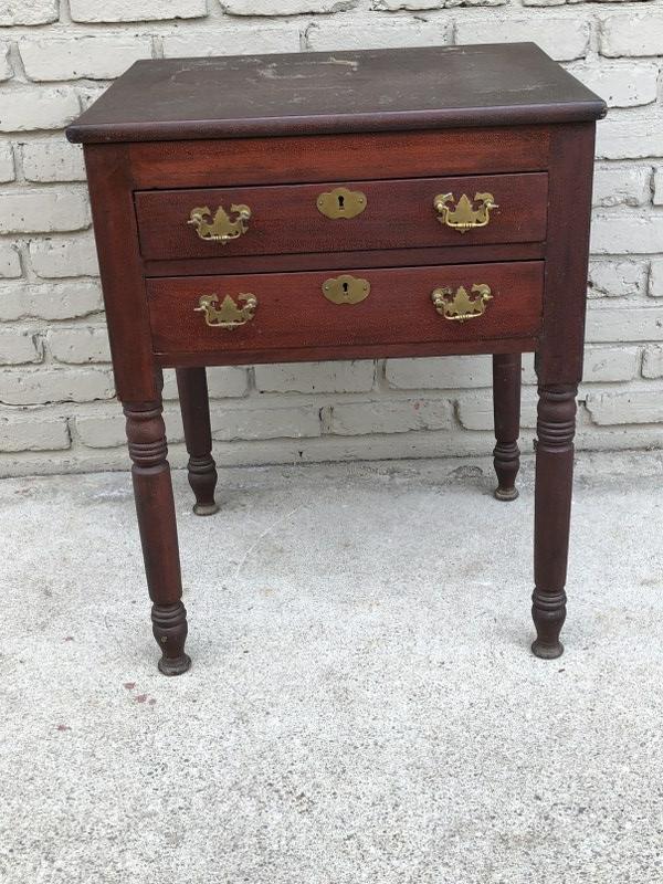 (2) DRAWER CHERRY COUNTRY STAND, 19TH CENTURY, CRACKLED: (2) DRAWER CHERRY COUNTRY STAND, 19TH CENTURY, CRACKLED FINISH FROM AGE, FROM LOCAL ULSTER COUNTY, N.Y. ESTATE, SOLID STRUCTURALLY, HAS BRASS PULLS & ORIGINALLY HAD WOOD KNOBS. MEASURES 27.5" H X 22" 