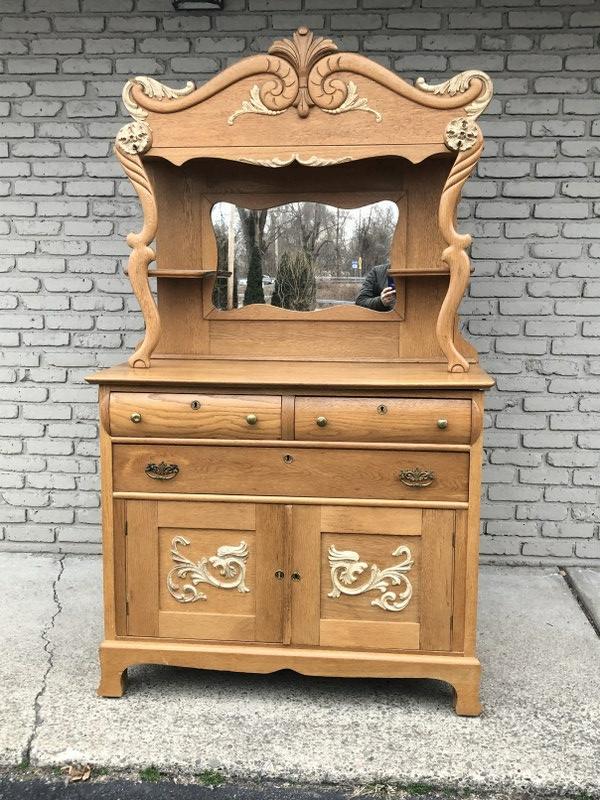 CIRCA 1900 OAK CARVED SIDEBOARD, WITH MIRROR AND: CIRCA 1900 OAK CARVED SIDEBOARD, WITH MIRROR AND GALLERY TOP, SUPER CLEAN, AND STRUCTURALLY SOUND, FROM VERY NICE LOCAL HOME OF A WOMAN DOWNSIZING. MEASURES 44" WIDE X 21" DEEP AND 78" HIGH.