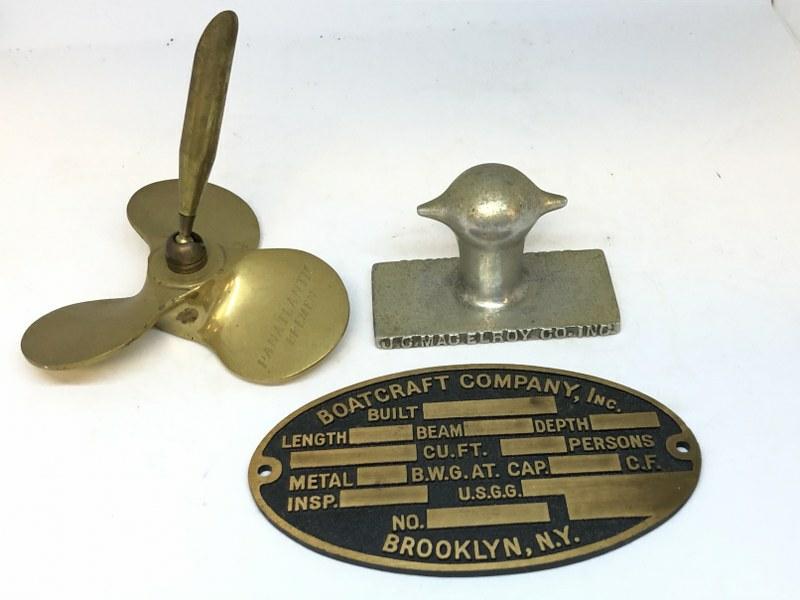OLD NAUTICAL COLLECTIBLE LOT FROM BROOKLYN ESTATE,: OLD NAUTICAL COLLECTIBLE LOT FROM BROOKLYN ESTATE, INCLUDES BOATCRAFT COMPANY BRASS PLATE, BRASS PROPELLER PEN HOLDER WITH PANATLANTIC BREMEN ENGRAVED, AND J C MACELROY CO. STEEL PRODUCTS PAPERWEIGHT.