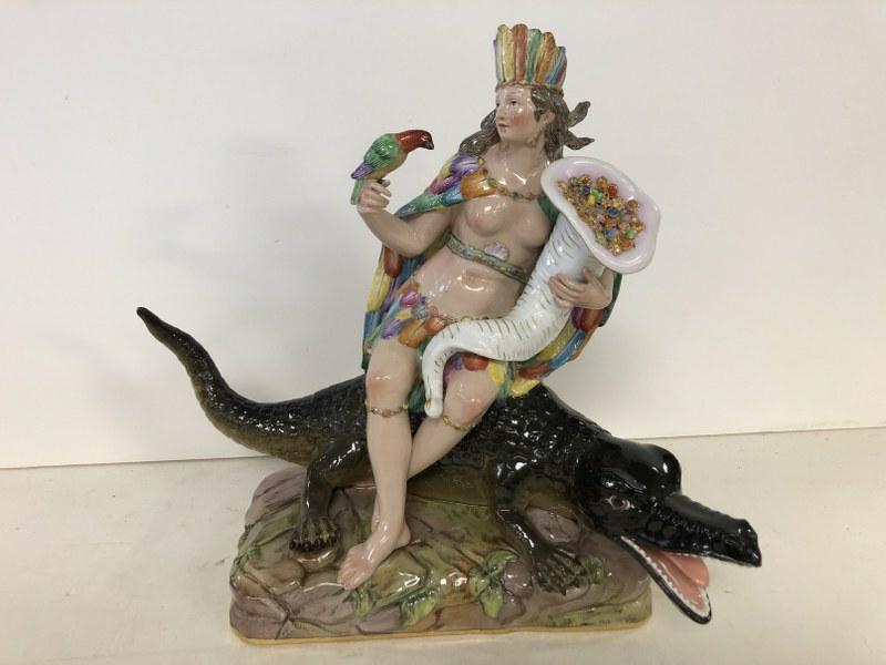 MEISSEN PORCELAIN THE AMERICAS FIGURE, FROM THE: MEISSEN PORCELAIN THE AMERICAS FIGURE, FROM THE ALLEGORIES OF THE FOUR CONTINENTS. PROBABLY EARLY 19TH C. MEASURES 11.25" HIGH X 12.5" WIDE (ALLIGATOR TAIL TO NOSE). CONDITION REPORT- ONLY THING I CAN