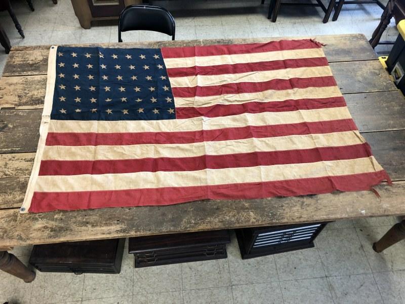 WW II (48) STAR AMERICAN FLAG, FROM LOCAL VETERANS: WW II (48) STAR AMERICAN FLAG, FROM LOCAL VETERANS ESTATE, STYLE D 4' X 6', SLIT THROUGH 2 STARS AND SOME TATTERED EDGES.