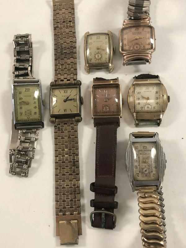 (7) VINTAGE RECTANGULAR MEN'S WRISTWATCHES, FROM: (7) VINTAGE RECTANGULAR MEN'S WRISTWATCHES, FROM BROOKLYN ESTATE WE ARE LIQUIDATIING. IN AS FOUND CONDITION, AS PICTURED, NO GOLD, INCLUDES LA FORGE, ABRA, BULOVA, BULOVA, BENRUS, GRUEN VERI-THIN & BU