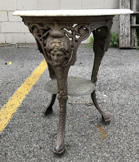 IRON BASE GARDEN TABLE WITH MARBLE TOP, FACES ON THE (1 of 3)