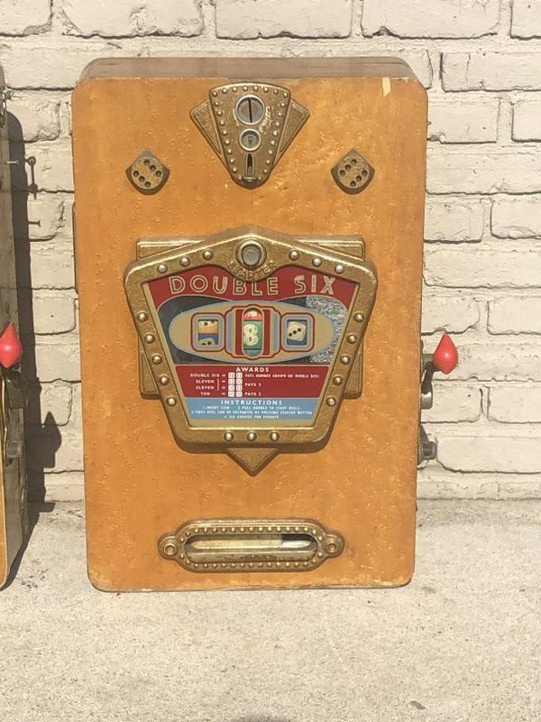 OLDER WOOD ( DOUBLE SIX) HANGING SLOT MACHINE IN AS: OLDER WOOD ( DOUBLE SIX) HANGING SLOT MACHINE IN AS FOUND ESTATE CONDITION, WORKS INTACK, WAS HANGING IN THE PAYROOM BAR, BODY HAS SOME VENEER ON TOP AND SMALL PIECE ON FRONT, BODY MEASURES 29" H X 18