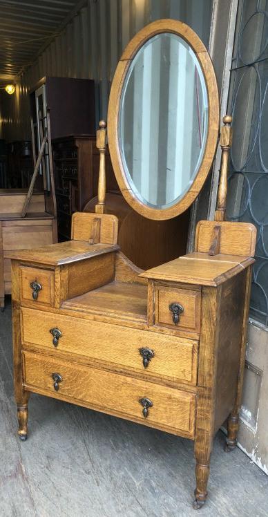 OAK 1920S DRESSER WITH OVAL MIRROR, SPLIT ON ONE SIDE: OAK 1920S DRESSER WITH OVAL MIRROR, SPLIT ON ONE SIDE OF THE DRESSER TOP THAT NEEDS TO BE REGLUED, MEASURES 34" W x 17" D x 65" H TO TOP OR MIRROR