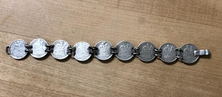 SILVER BRACELET WITH SEATED LIBERTY DIMES, 1870'S AND: SILVER BRACELET WITH SEATED LIBERTY DIMES, 1870'S AND 1880'S, ALL THE BACKS ARE BEAUTIFULLY MONOGRAMMED. FROM LOCAL ESTATE.