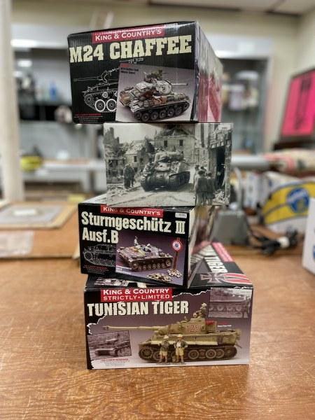 FOUR KING & COUNTRY WWII TANK MINIATURES IN BOX. THIS: FOUR KING & COUNTRY WWII TANK MINIATURES IN BOX. THIS LOT INCLUDES AK038 (STURMGESCHÃœTZ III AUSF. B), AK039(SL) (TUNISIAN TIGER), BBA018 (M24 CHAFFEE), AND DD65 (BRITISH EDITION SHERMAN). MANY OF T