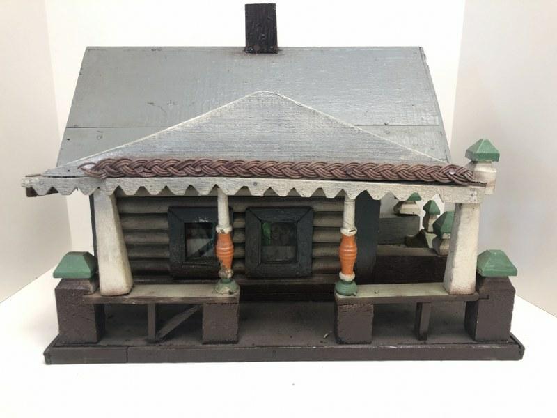 Circa 1940's or so Folkart cabin with nice detail, with porcelain heads looking out the 2 front (1 of 7)