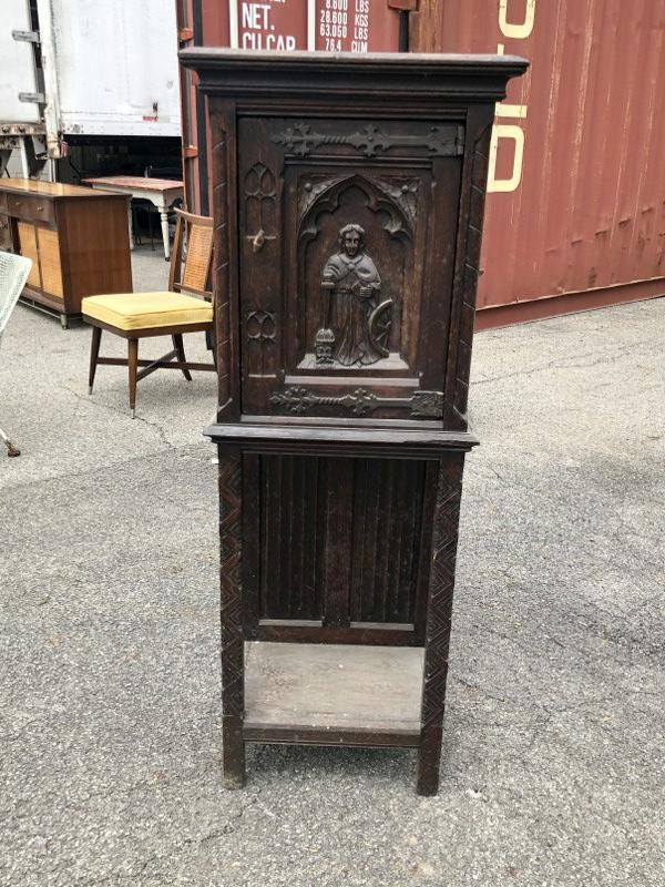 Oak church cabinet with carved figures, found in the estate garage, measures 50" high x 18.5" wide x: Oak church cabinet with carved figures, found in the estate garage, measures 50" high x 18.5" wide x 13.5" deep, top has some stainingâ€¦. From Hudson, N.Y. estate of noted Art Collector Albert Bu