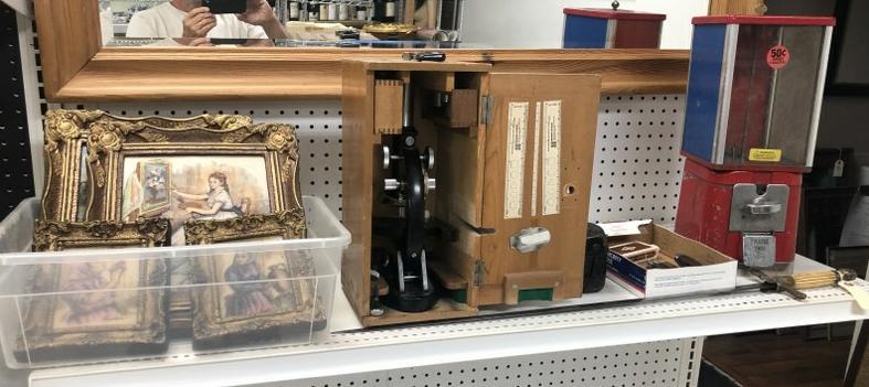 Misc. estate lot incl. sword, candy coin operated machine, microscope in case, mechanical Bali (?) (1 of 11)