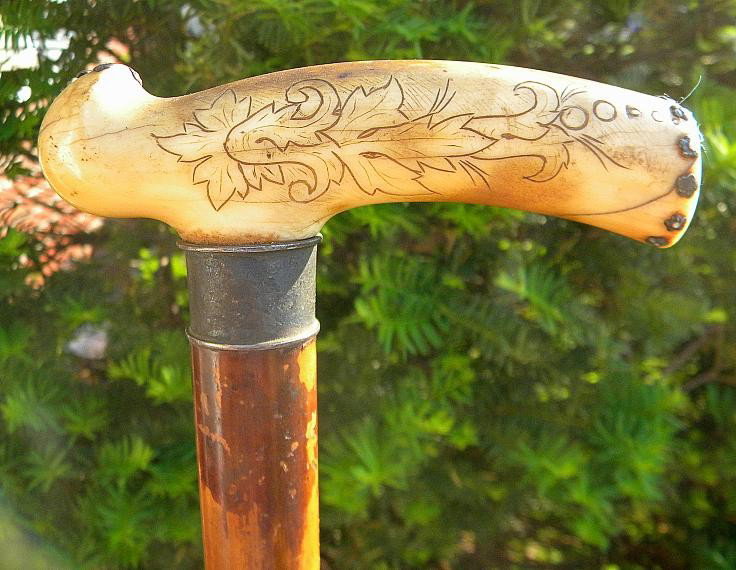 OLD IVORY OR BONE HANDLE CAN WITH SCRIMSHAW DETAI: Nice old cane, either bone or ivory handle, with scrimshaw leaf design. Cane measures 34" top to bottom.