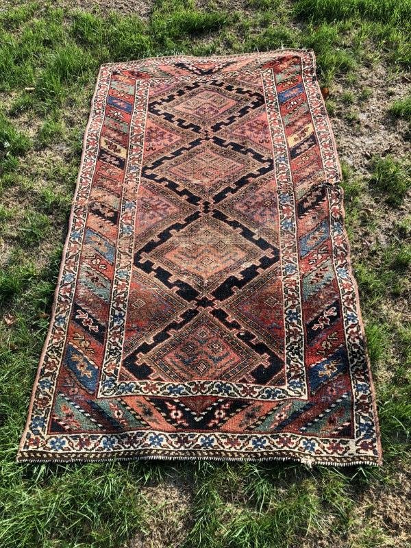 Estate handmade oriental rug, measures 82" x 45", wear on edges, one small tear as pictured. From (1 of 7)