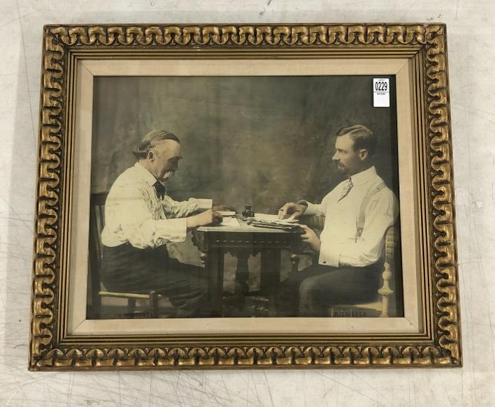 Hand Painted Photograph of (2) men at writing table, identified as " A. MacConnell " and "R.D.: Hand Painted Photograph of (2) men at writing table, identified as " A. MacConnell " and "R.D. Kidder". Frame measures 21" x 25". From the estate collection of Richard G. Miller's 19th & 20th century 