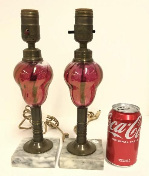Pair cranberry glass converted oil lamps to electric, on marble bases. They measure 12" high to: Pair cranberry glass converted oil lamps to electric, on marble bases. They measure 12" high to socket.