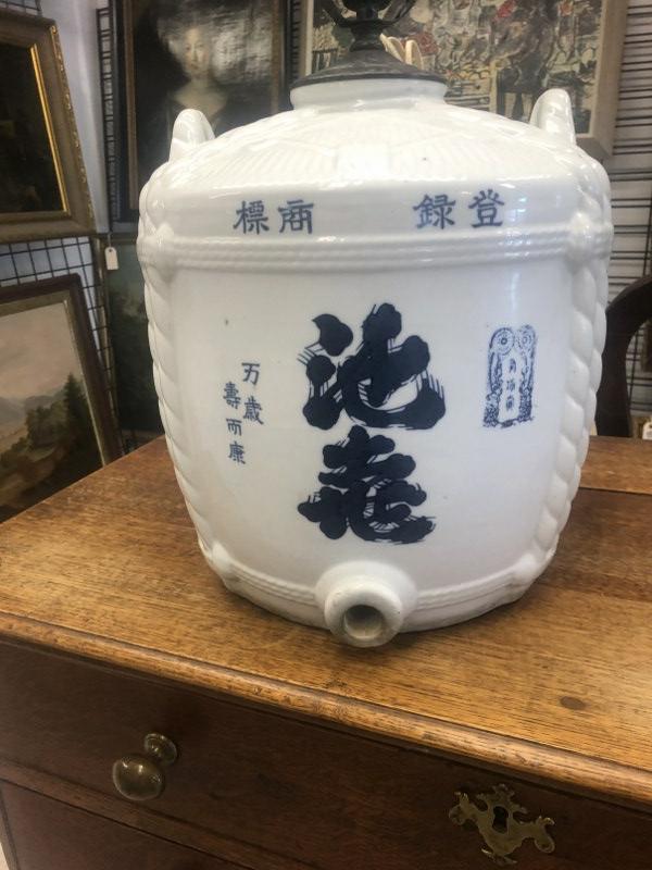 Old Japanese sake barrel converted in to table lamp, with Asian markings as pictured. Measures: Old Japanese sake barrel converted in to table lamp, with Asian markings as pictured. Measures approx. 14" high to top of vessel, and 26" to top of harp. From Catskill, N.Y. estate of a fine gentleman
