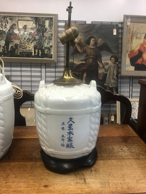 Old Japanese sake barrel converted in to table lamp, with Asian markings as pictured. Measures: Old Japanese sake barrel converted in to table lamp, with Asian markings as pictured. Measures approx. 13" high to top of vessel, and 23" to top of harp. From Catskill, N.Y. estate of a fine gentleman