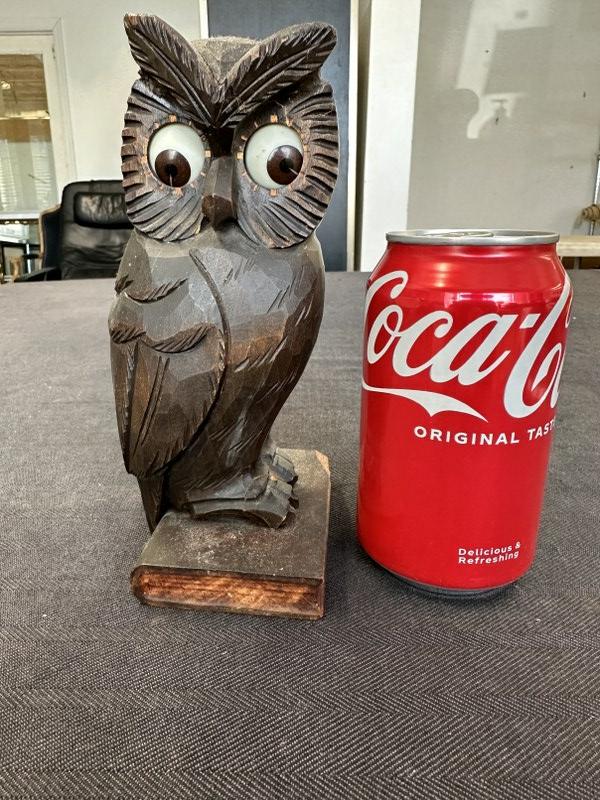 Made in Germany carved owl clock with glass eyes, not running, small piece broken off foot and: Made in Germany carved owl clock with glass eyes, not running, small piece broken off foot and corner of book base, measures 8" high. Stamped Made in Germany.