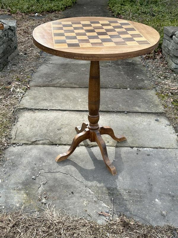Older game table with checker board top, with chess pieces walnut & oak pieces on top, structurally: Older game table with checker board top, with chess pieces walnut & oak pieces on top, structurally sound, from estate in Hudson Valley, top measures 24" across x 29" high.