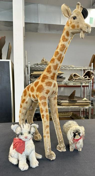 Estate STEIFF (3) pc. Lot to incl. 29" high giraffe, cat and dog. Giraffe & Cat have buttons in ear,: Estate STEIFF (3) pc. Lot to incl. 29" high giraffe, cat and dog. Giraffe & Cat have buttons in ear, giraffe show some body wear in spots and bottom of feet. Just as we found them. The giraffe has a s