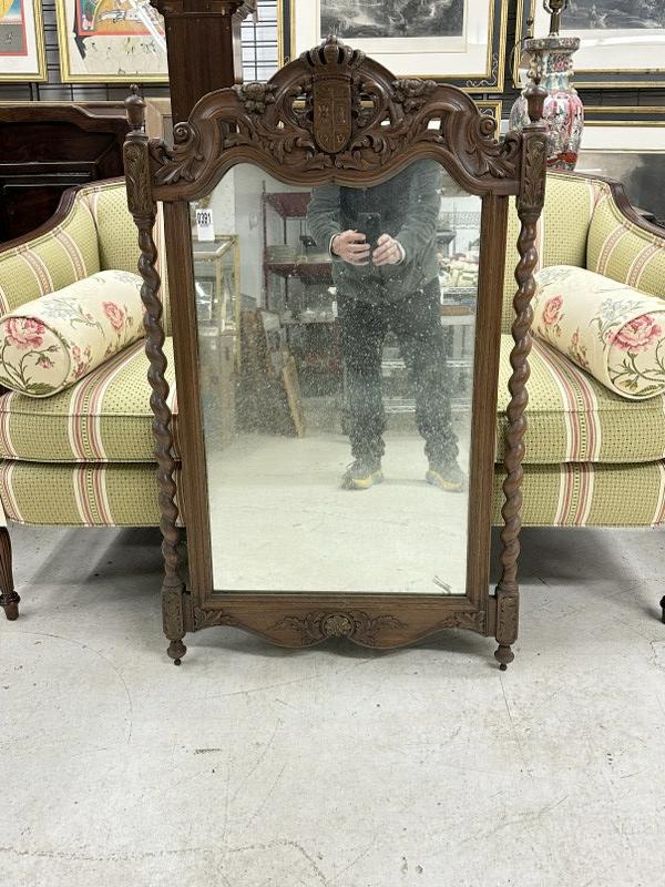 Old walnut decorative mirror with crest on top and nice carvings, from local estate, measures 43" x: Old walnut decorative mirror with crest on top and nice carvings, from local estate, measures 43" x 25.5".