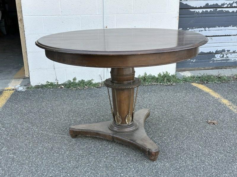 Round walnut pedestal table, with decorative brass leaves on base, ( table has no leaves ),: Round walnut pedestal table, with decorative brass leaves on base, ( table has no leaves ), structurally sound, nice estate condition, measures 44" across x 30" high. Would look nice as a center table