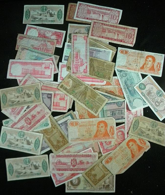 Lot of Early Foreign Paper Currency: Lot of early foreign paper currency including Columbia, Paraguay, Guyana, Venezuela, El Salvador, Uruguay, Jamaica, Trinidad and Tobago, Bolivia and Argentina, 1950's -7-'s, as pictured, some torn