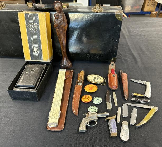 Misc. estate lot to include some knives, old Kodak camera in box, carved statue, drafting ruler in: Misc. estate lot to include some knives, old Kodak camera in box, carved statue, drafting ruler in case, some Rod & Gun club pins from Rifton, N.Y. and toy cap pistol.