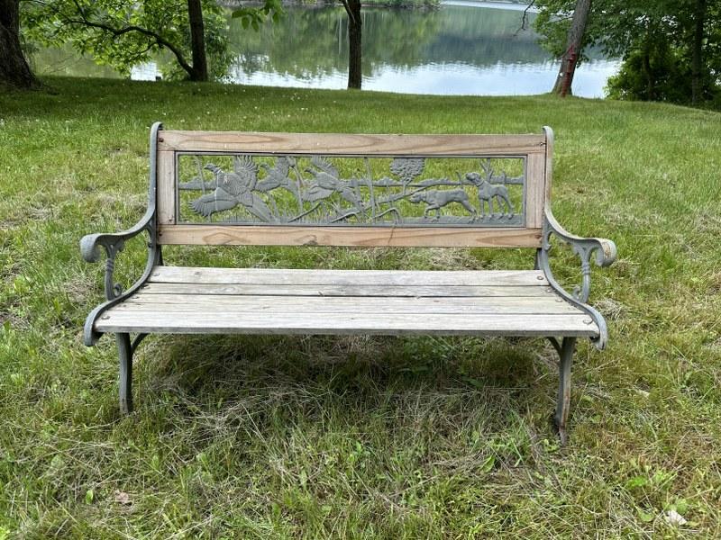 Outdoor bench with iron sides & back, with outdoor motif, measures 49.5" wide x 31" high. (1 of 2)