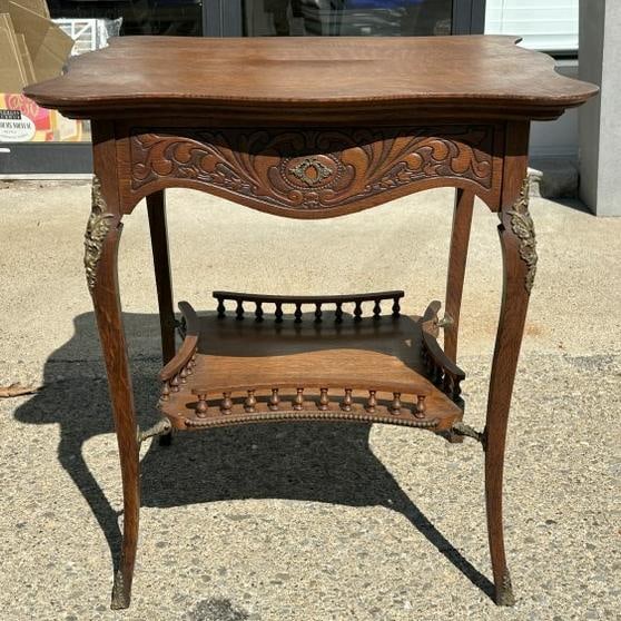 Circa 1910 quarter sewn oak carved table with bronze mounts on legs and feet, with gallery on bottom (1 of 8)