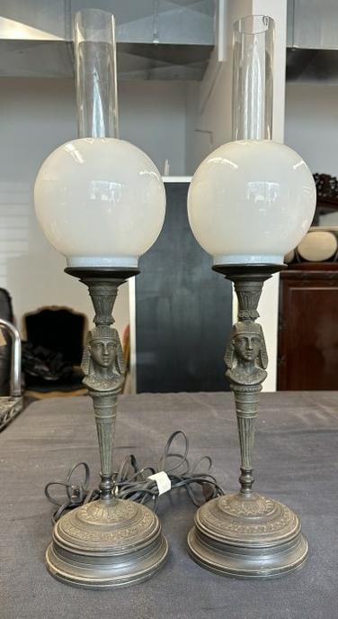 Pair Egyptian Revival lamps from NYC estate, nice overall condition, made of a white metal, they: Pair Egyptian Revival lamps from NYC estate, nice overall condition, made of a white metal, they measure 22" high to top of chimneysâ€¦
