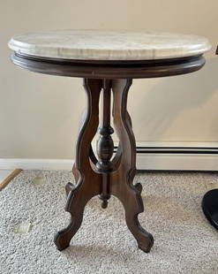 Small oval Victorian marble top walnut table, nice estate condition, structurally sound. Measures: Small oval Victorian marble top walnut table, nice estate condition, structurally sound. Measures 22" across top x 17 1/2" deep x 27 1/2" high.