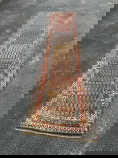 Handmade wool oriental runner, from fine estate's indoor climate controlled storage facility, in: Handmade wool oriental runner, from fine estate's indoor climate controlled storage facility, in storage over 20 years, has a few small holes, and wear mostly on one end, good looking pattern. Measure