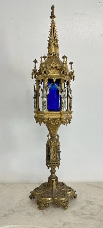 Decorative old brass Church candleholder with figure on top, winged figures around the center and (1 of 9)