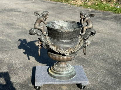 Large brass vintage planter with (2) figural cherubs on handles, in old patina, was on back porch of: Large brass vintage planter with (2) figural cherubs on handles, in old patina, was on back porch of fine estate in Chester, New York. Nice older patina, probably made in last 3- years or so is my gue