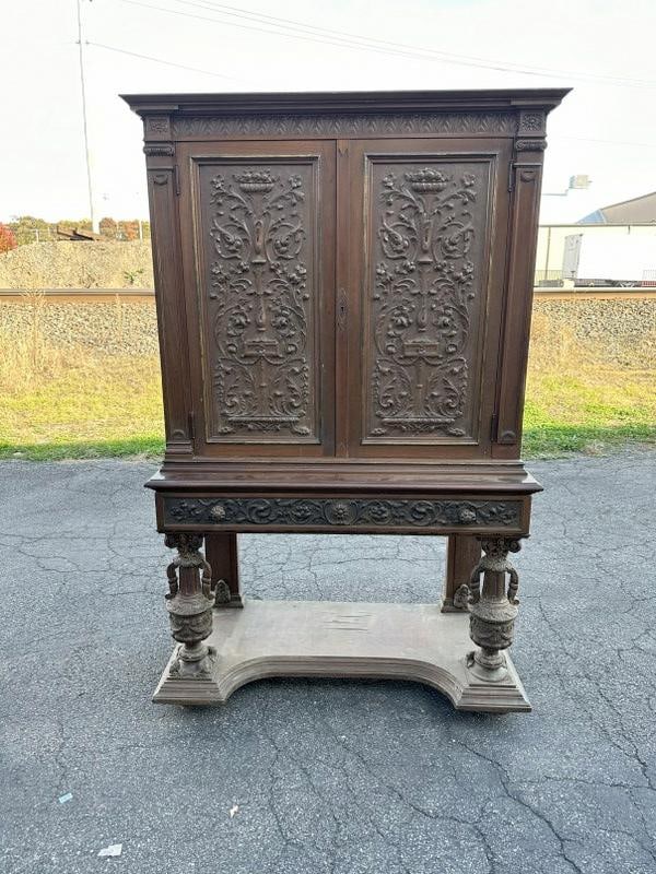 Circa 1900 heavily carved walnut cabinet, from big estate in Highland, N.Y. Structurally sound, a: Circa 1900 heavily carved walnut cabinet, from big estate in Highland, N.Y. Structurally sound, a few veneer pieces lifted up on base, does not detract from this good looking cabinet. Measures 71 1/2"