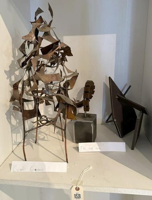 Lot of three medium sculptures by Glen Mayo. "Copper Crossroads" is comprised of hand-cut copper: Lot of three medium sculptures by Glen Mayo. "Copper Crossroads" is comprised of hand-cut copper panels with patina and is the tallest of the lot at 25". "The Loop Route" segmented 1" steel tubing wit
