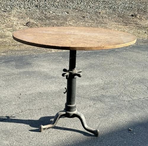 Adjustable industrial iron base table w/plywood top, measures 34" W X 30" H. (1 of 4)