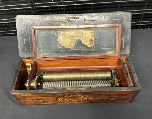 Rosewood inlaid music box, working condition, ( trim that holds the glass in needs to be reattached,: Rosewood inlaid music box, working condition, ( trim that holds the glass in needs to be reattached, loose and glass slipping ), from Hudson Valley estate, measures 19" long x 7" deep x 5.25" high. So