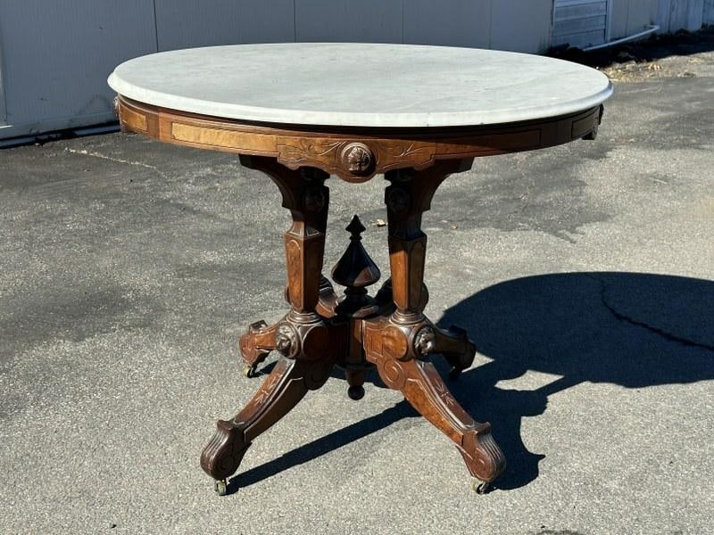Victorian oval top marble table w/lion heads on base, a few pieces of trim  off the base, measures (1 of 6)