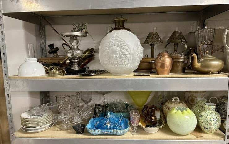 (2) large shelves of estate glassware,porcelains, oil lamps including one with raised child heads on (1 of 16)