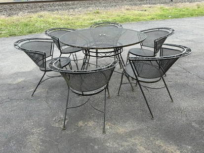Circa 1950's round metal outdoor table with (6) armchairs, nice estate condition. Table measures 48": Circa 1950's round metal outdoor table with (6) armchairs, nice estate condition. Table measures 48" across the top.