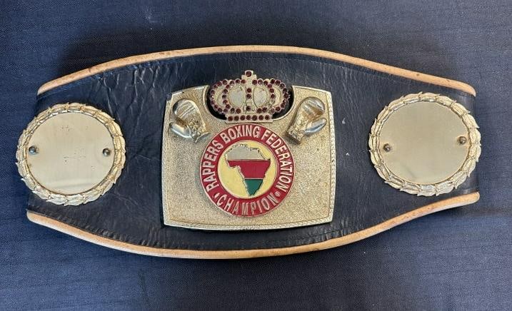 RAPPERS BOXING FEDERATION CHAMPION belt, from estate of Gary Braverman, who promoted these fights.: RAPPERS BOXING FEDERATION CHAMPION belt, from estate of Gary Braverman, who promoted these fights. The belt opened measures 42" long.