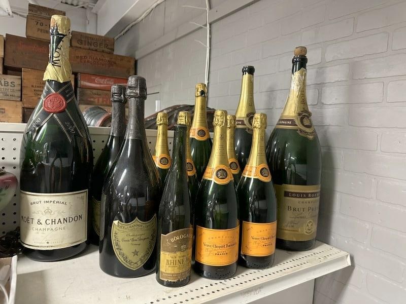 Big lot vintage display Champagne bottles including oversized, from local estate who used them as: Big lot vintage display Champagne bottles including oversized, from local estate who used them as props throughout the house. Tallest measures 23" high. Nice lot for dealer to sort out….