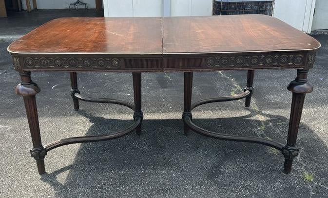 Decorative walnut 1920's dining room table w/5 leaves and carving around apron, some pcs of trim off (1 of 6)