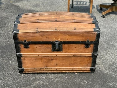 Dome top trunk with wood insert tray on top, good estate condition. Measures 22.5" high x 31" wide x