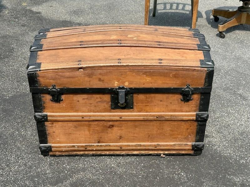 Dome top trunk with wood insert tray on top, good estate condition. Measures 22.5" high x 31" wide x (1 of 4)