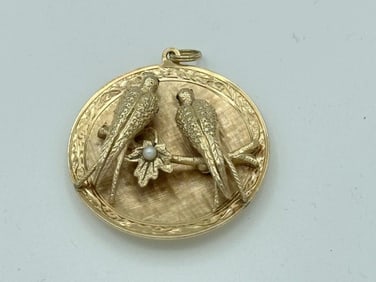 14k pendant with 2 birds on branch with pearl center in leaf, lightly inscribed on back, weighs 13.6
